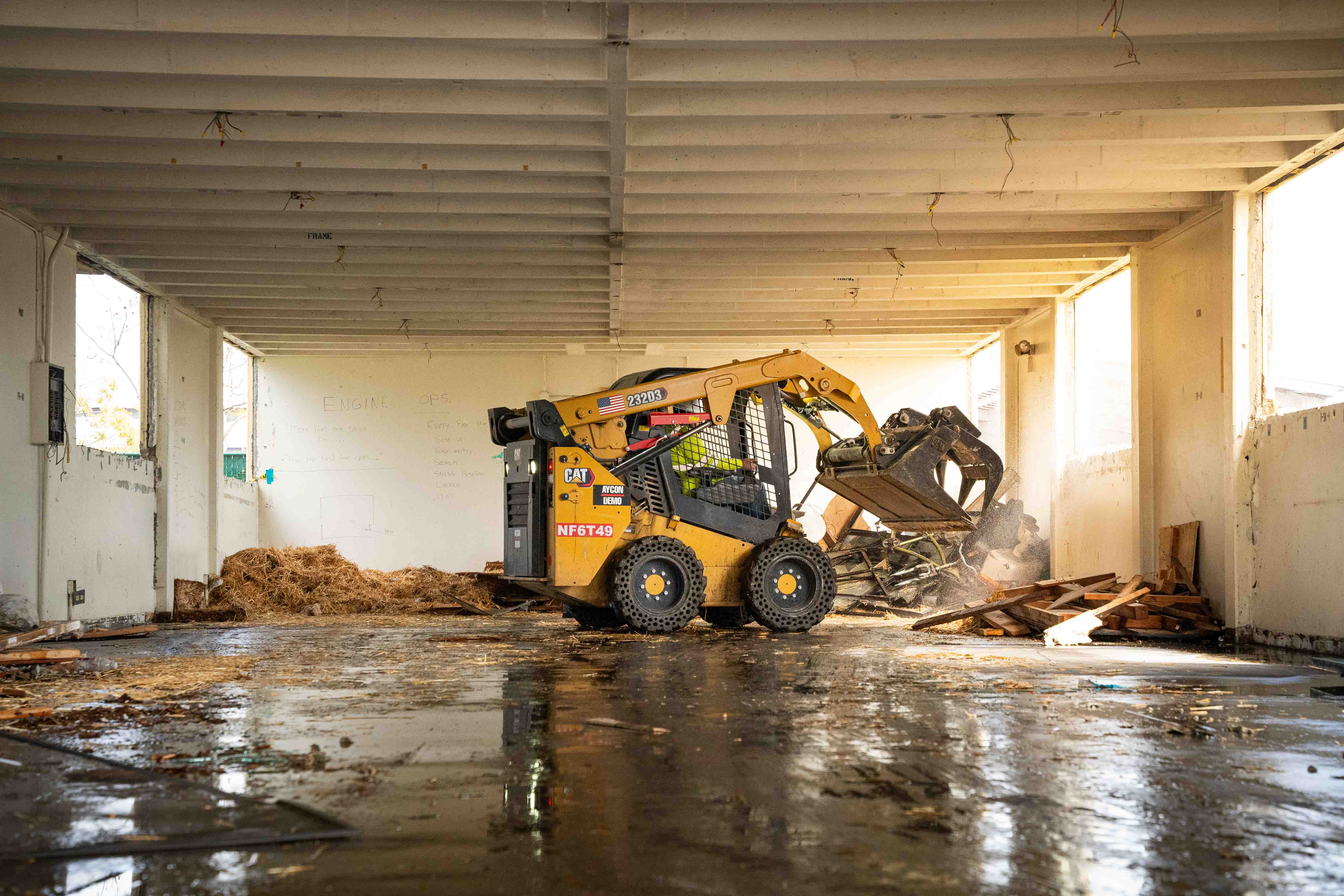 Bay Groundworks skid steer clearing a building interior
